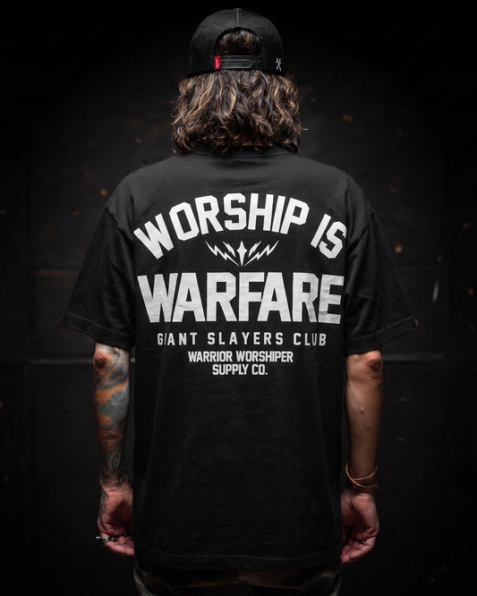 [NEW] FLAGSHIP WORSHIP IS WARFARE PREMIUM OVERSIZED TEE IN RUSTIC BLACK 7.5 oz