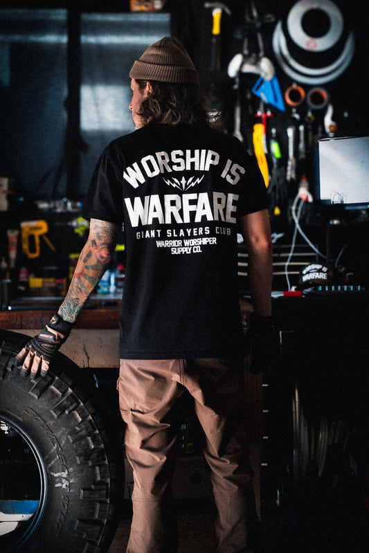 FLAGSHIP WORSHIP IS WARFARE PREMIUM STANDARD ISSUE TEE IN BLACK